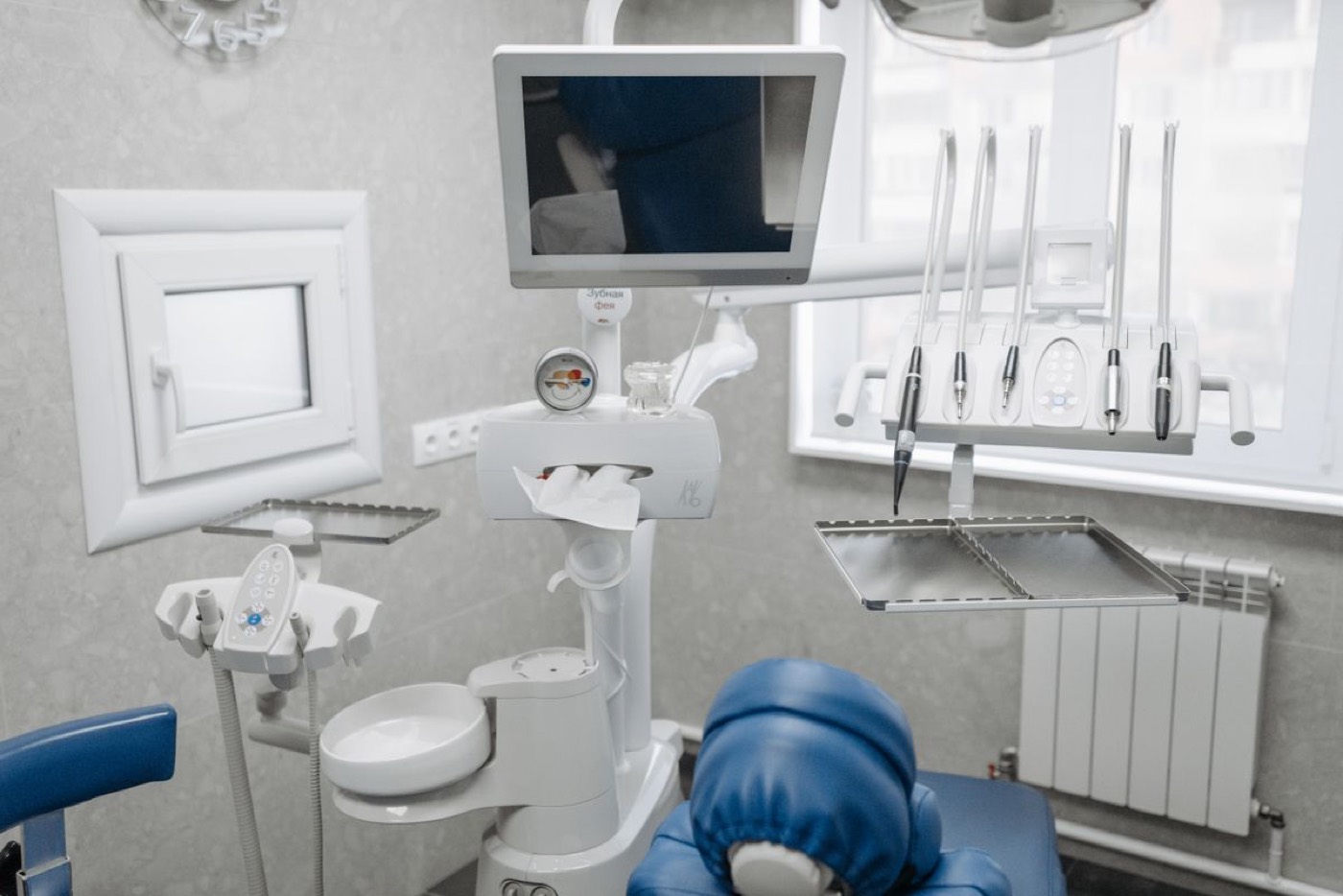 A treatment room with a chairside screen and instruments